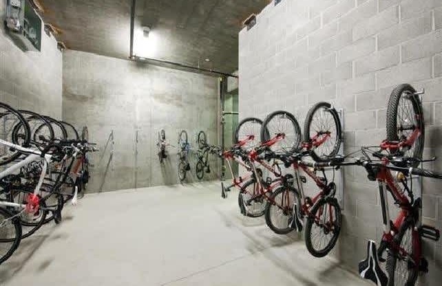 A bike rack with many bikes parked in a garage.