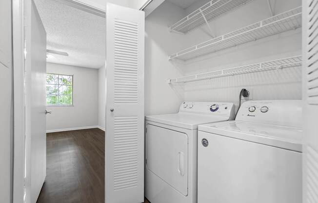 A white laundry room with a washer and dryer.