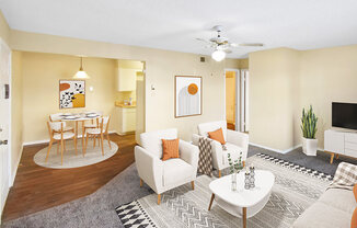 A living room with a white couch, a coffee table, and a ceiling fan.