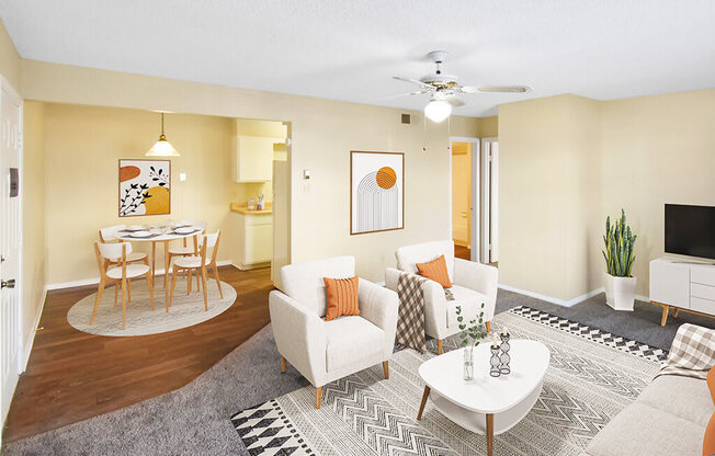 A living room with a white couch, a coffee table, and a ceiling fan.
