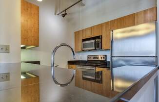 a kitchen with stainless steel appliances and a stainless steel sink