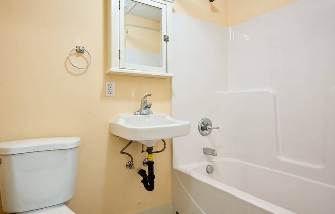 a bathroom with a sink toilet and bathtub