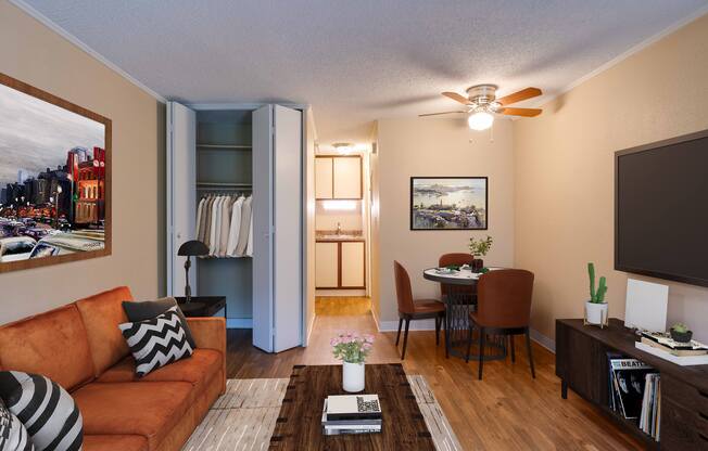 A living room with a brown couch, a coffee table, and a painting on the wall.