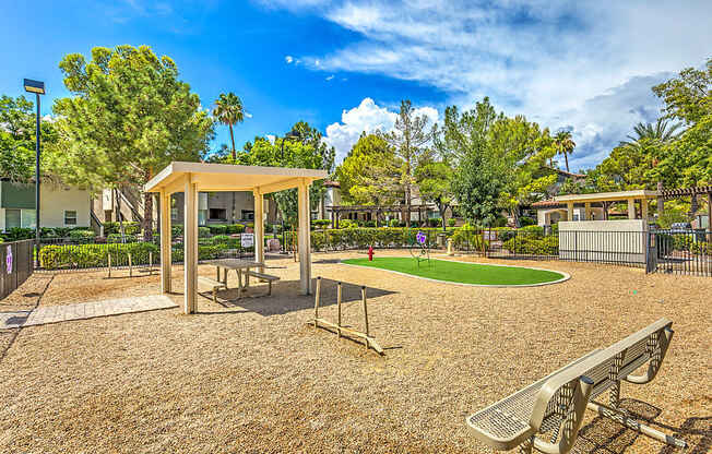 A playground with a swing set and a picnic table.