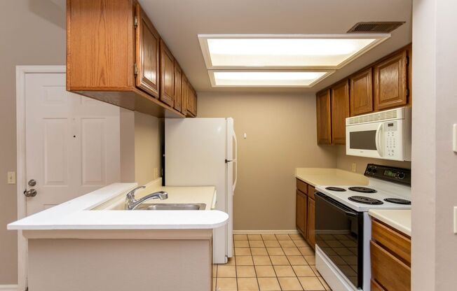 Cozy 2-Bed Condo with Fireplace, Garage & Pool Access Near Shopping!