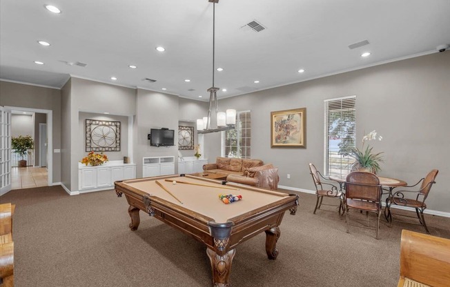 a game room with a pool table and a television