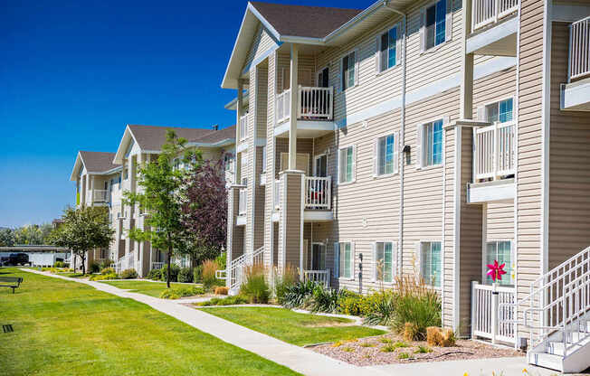 A row of apartment buildings with a clear blue sky above.