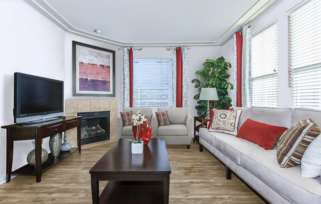 a living room filled with furniture and a flat screen tv