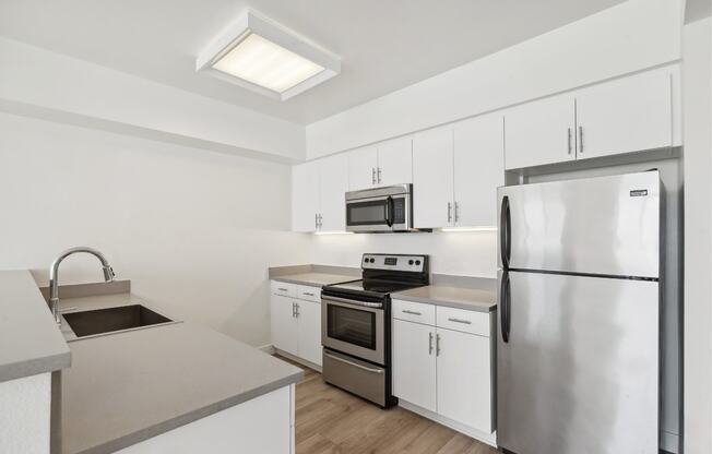 luxury kitchen with custom cabinets and stainless steel appliances at One Santa Fe luxury apartments