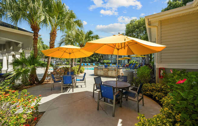 A patio with a table and chairs under an umbrella.