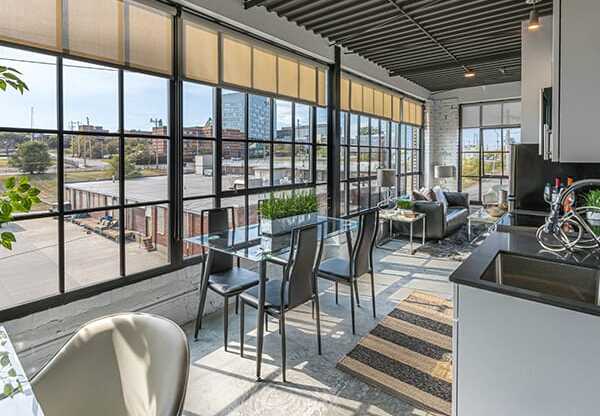 Steelcote Crossing living area with dinning room table and oversized windows at Steelcote Square, St. Louis