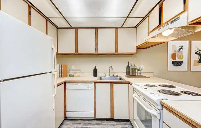 a kitchen with white appliances and wooden cabinets