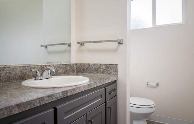 an empty bathroom with a sink and a toilet