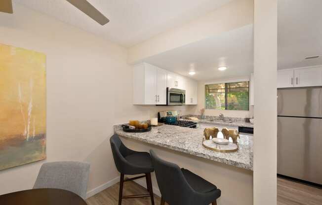 a kitchen with a granite counter top and stainless steel appliances