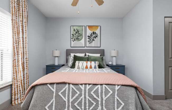 a bedroom with a bed and a ceiling fan at the Vue luxury apartments in Indianapolis