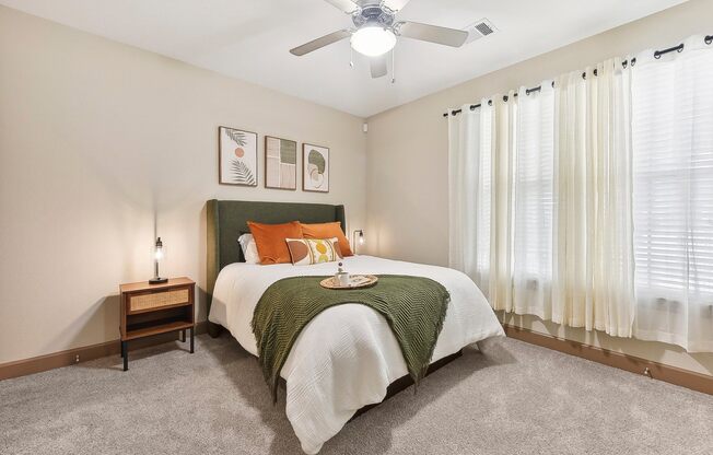 a bedroom with a bed and a ceiling fan at Lakeline East Apartments, Cedar Park