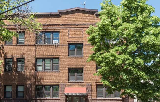 a brick building with a tree in front of it