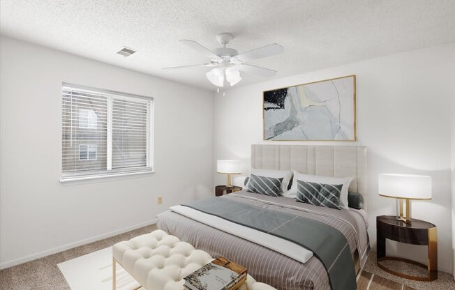 a bedroom with a bed and a ceiling fan