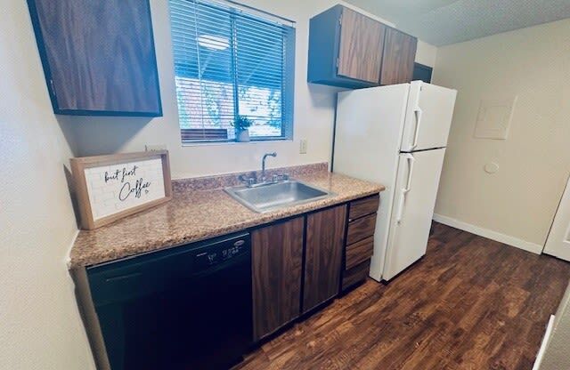 a kitchen with a sink and a refrigerator