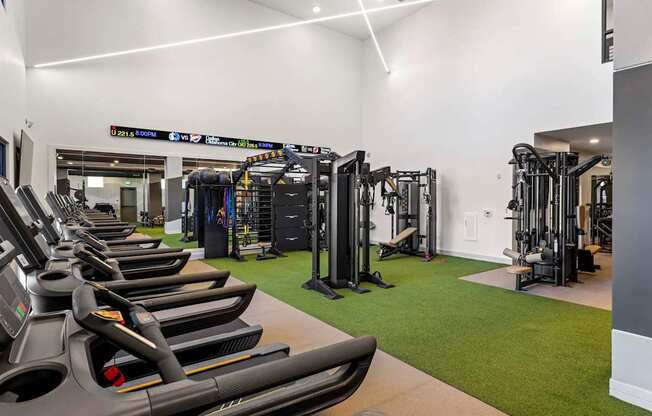 A gym with treadmills and other exercise equipment.