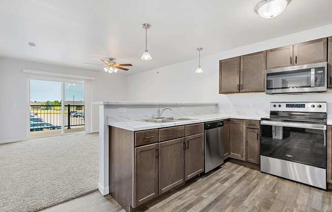 A kitchen with wooden cabinets and stainless steel appliances.