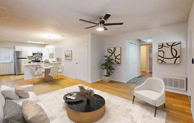 A living room with a white couch, a coffee table, and a ceiling fan.