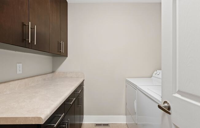 a washer and dryer in a laundry room at the flats at big tex apartments in