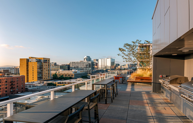 Rooftop grilling stations and dining tables with stunning Portland Pearl District views