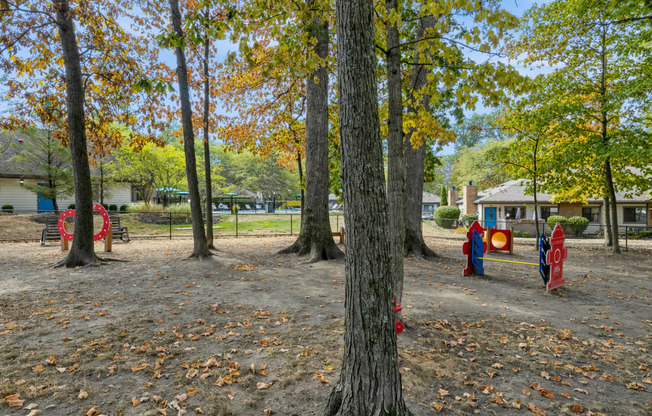 a playground in a park with trees and playground equipment