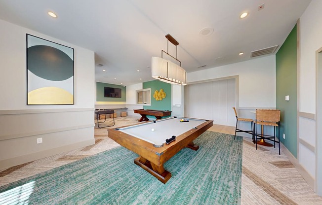 a game room with a pool table, shuffleboard and foosball table