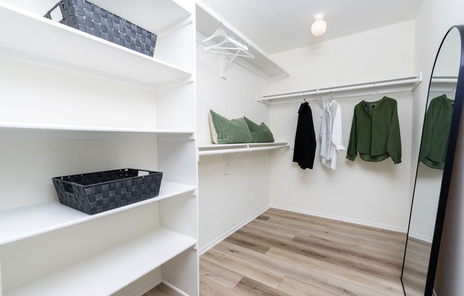 two pictures of a walk in closet with shelves and a mirror