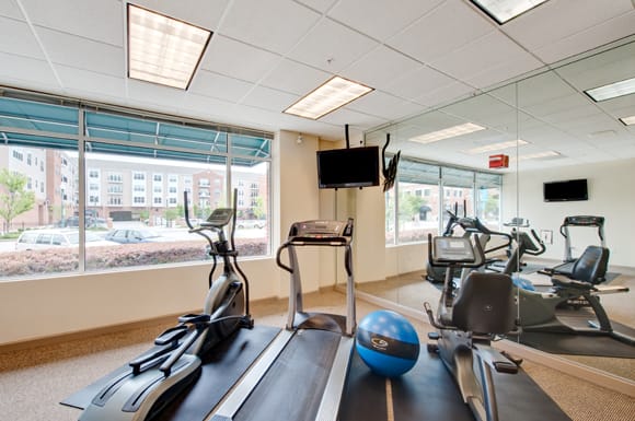 Fitness center with cardio equipment; flat screen TV