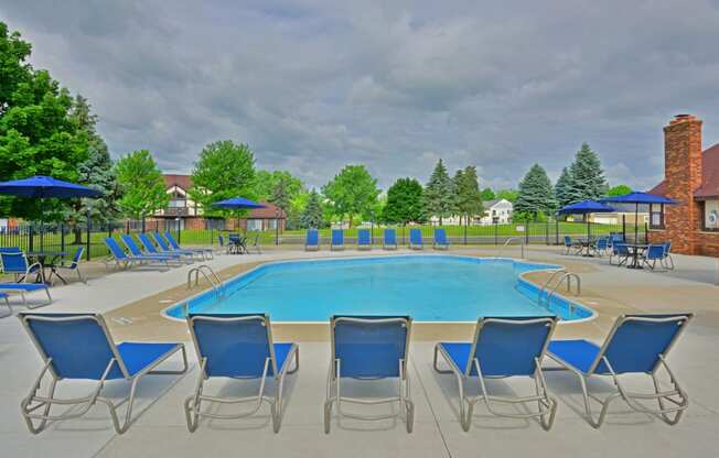 our apartments have a large pool with chairs and umbrellas