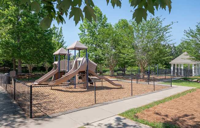 A playground with a slide and a gazebo.