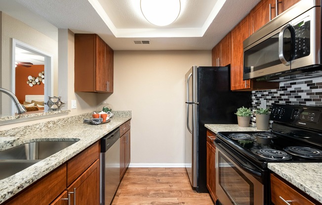 a kitchen with stainless steel appliances and granite counter tops