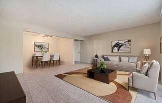 Omaha, NE Evergreen Terrace Apartments. A living room with a couch a table and a chair