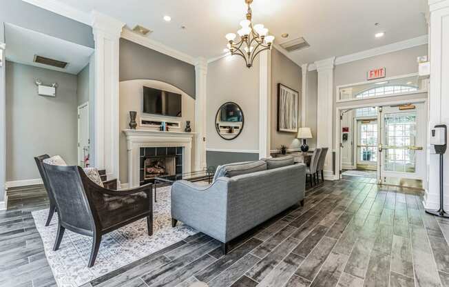 a living room with couches and chairs and a fireplace