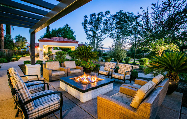 a patio with furniture and a fire pit