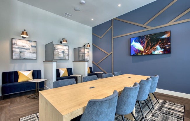 a conference room with blue chairs and a wooden table