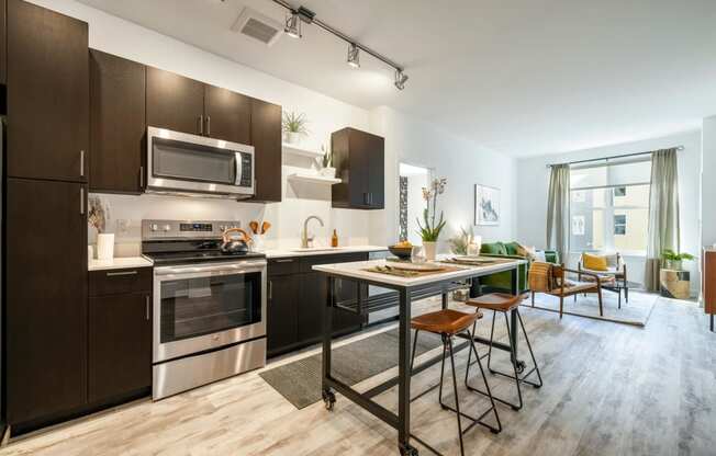 Model kitchen with stainless steel appliances and a table