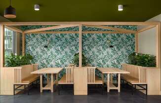 A room with a green wallpaper and wooden furniture.