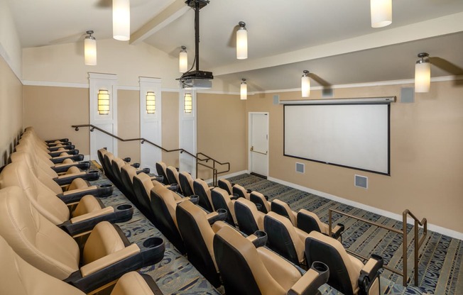 a large conference room with chairs and a projection screen