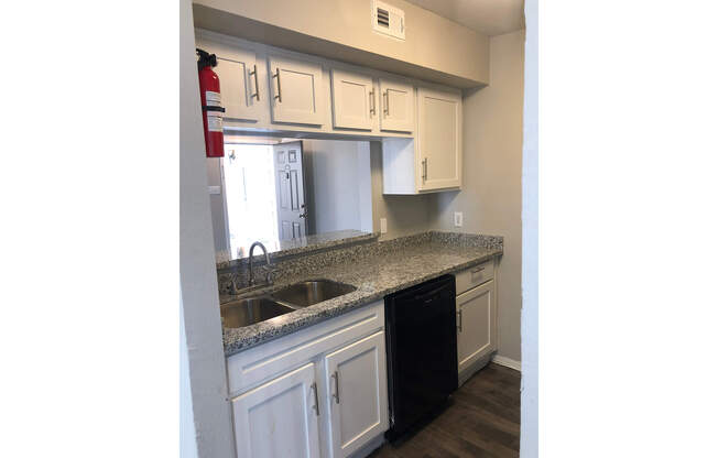 a stove top oven sitting inside of a kitchen