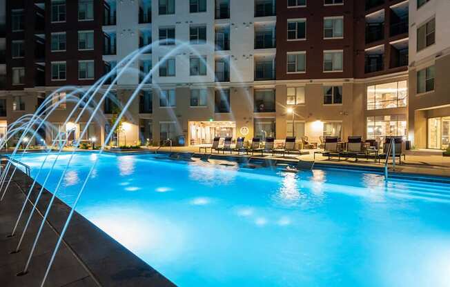 a swimming pool at a hotel with a water fountain