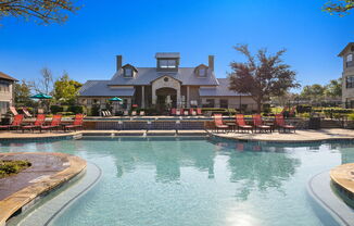 a large pool with chairs and a house in the background at The Fairways at Star Ranch, Hutto