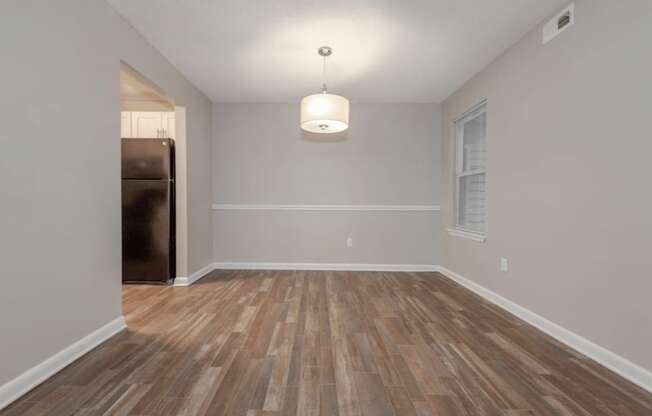 A room with wooden flooring and a light fixture on the ceiling.