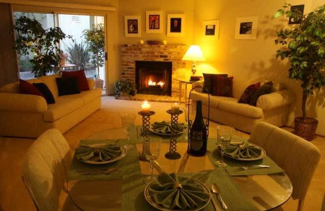 a living room with a table and chairs and a fireplace