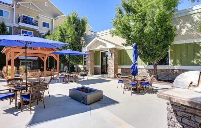 a patio with tables and umbrellas and a fire pit The Beckstead, South Jordan, UT, 84095