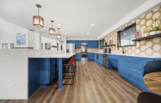 a kitchen with blue cabinets and white countertops