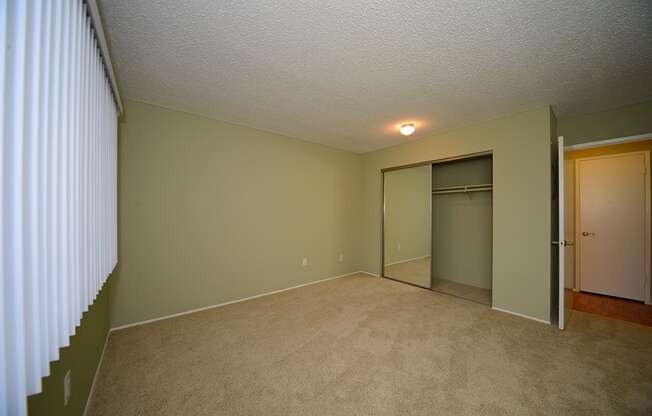 Ocean View Townhomes unfurnished bedroom with a mirror closet